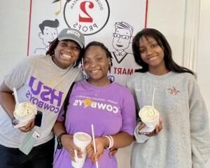 HSU students pose with their ice cream outside 2 Profs ice cream shop.